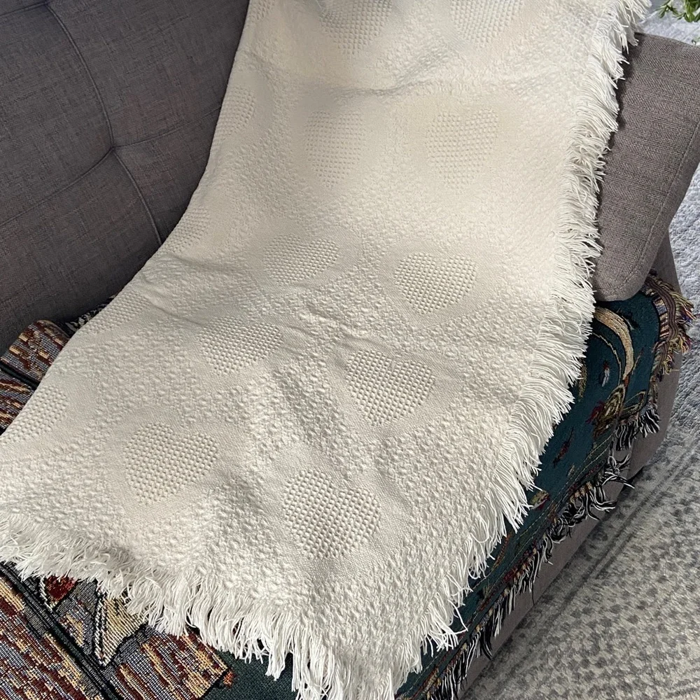 Beautiful white blanket with subtle heart detail.